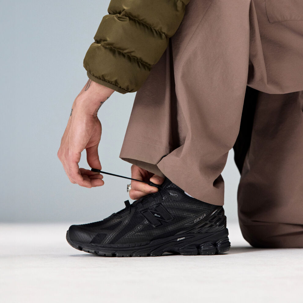 A blue shoe on a dark brown backdrop. 